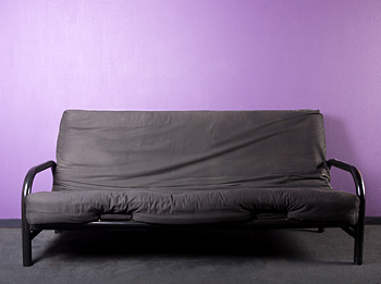 Futon Couch on Purple Wall Background